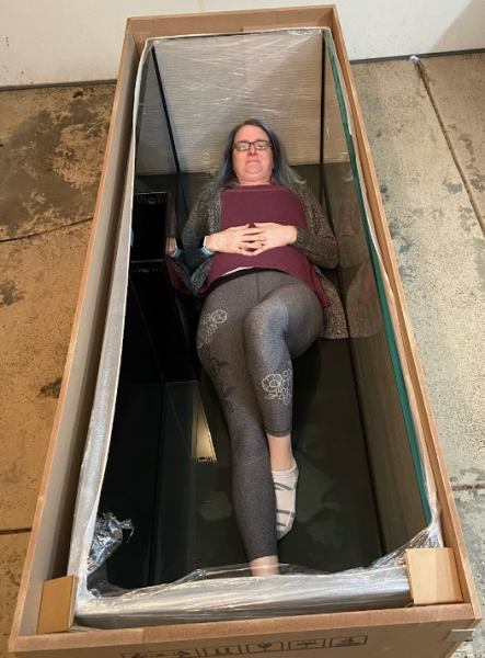 Stephannie Suddendorf lays in a fish tank to show just how big it is.