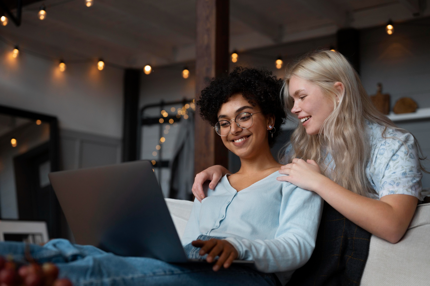 Lesbian couple looking on their laptop