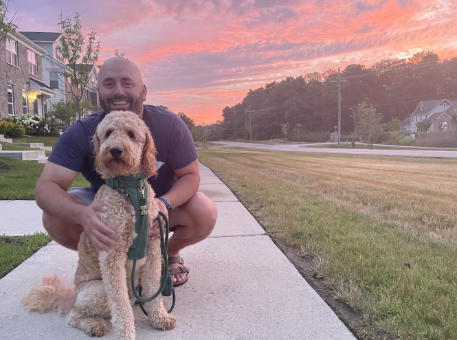 sunset and person kneeling with dog