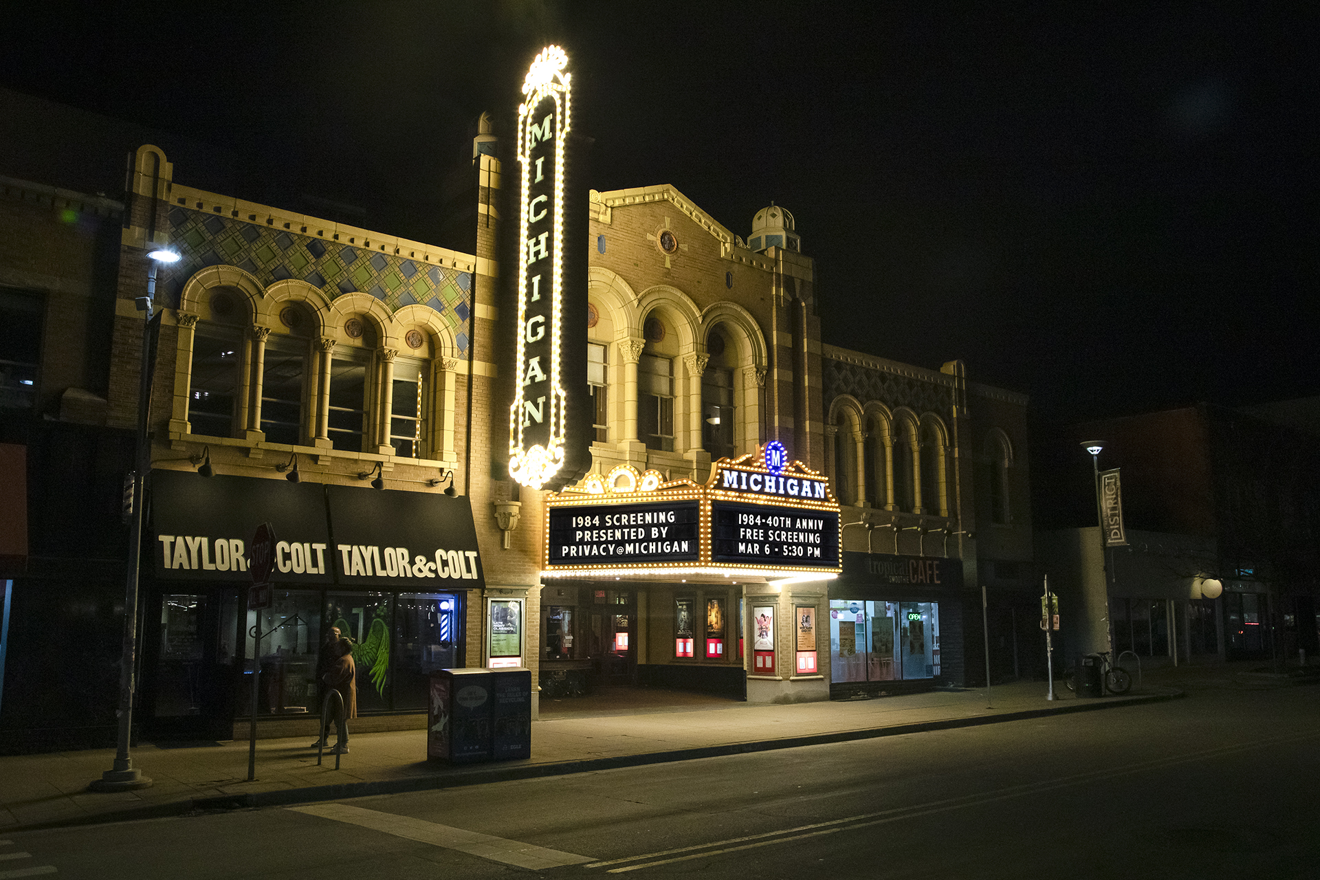 The Ann Arbor Michigan Theater marquee lit up at night. The marquee has information for the privacy at Michigan 1984 40th-anniversary screening.
