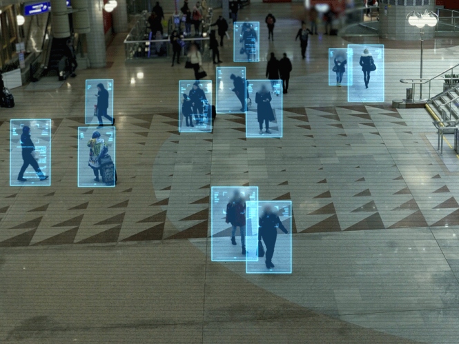 People walking across a public square. They are highlighted in neon blue squares.