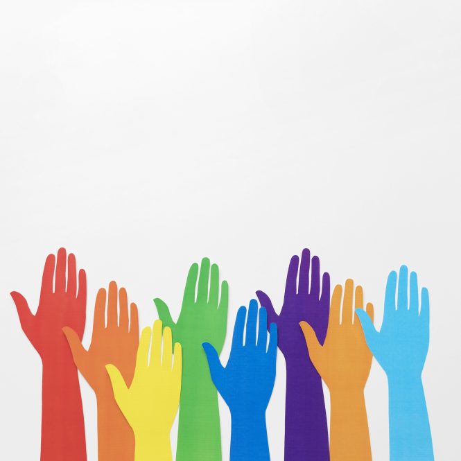 rainbow hands being raised against a gray background