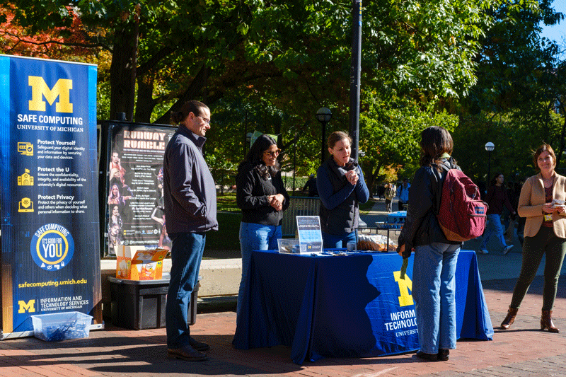 IA staff on the Diag talking with students about safe computing