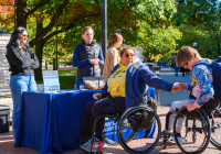 Students stop by the IA table on the Diag