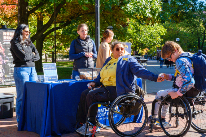 Students stop by the IA table on the Diag