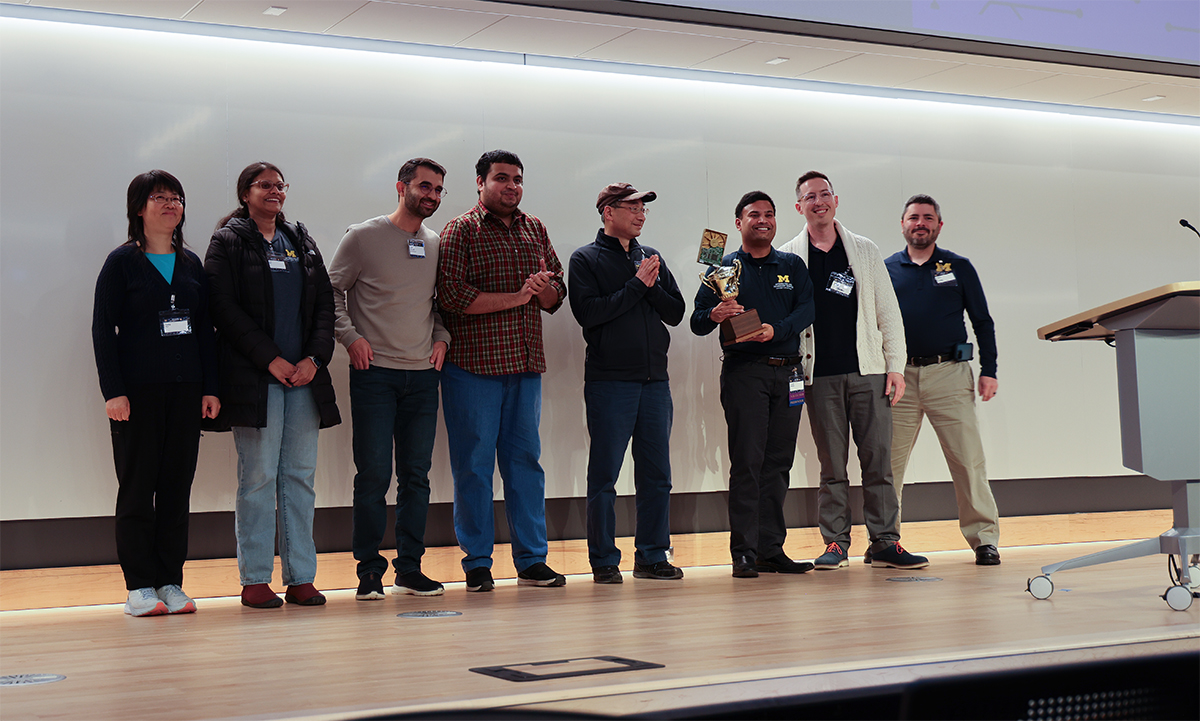 The Hacks With Friends winning team of both the judges' choice and the People's Choice standing on stage with their trophy.