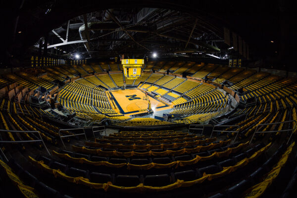Maized-out empty Crisler Center. Crisler Center decked out with maize t-shirts.
