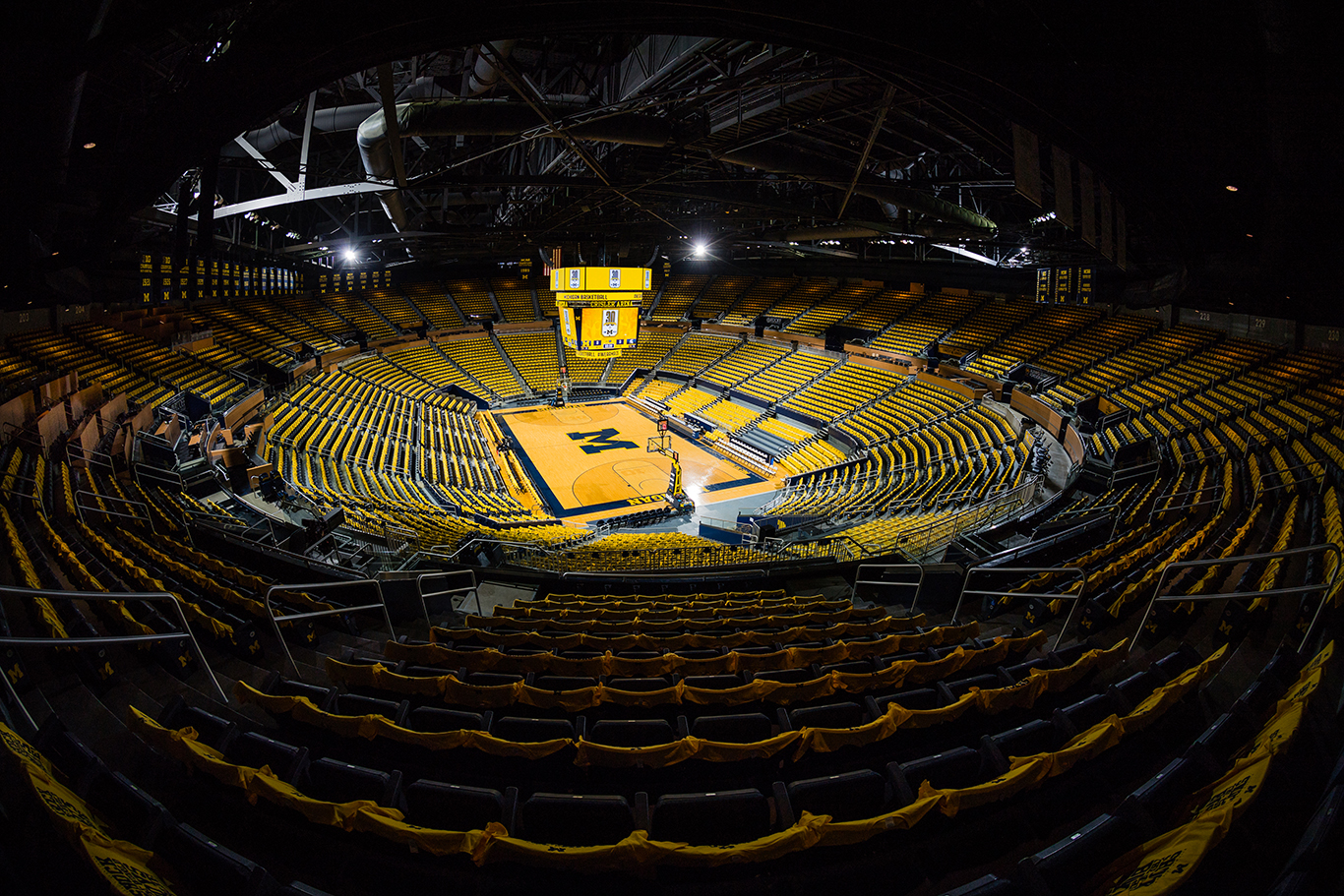 Maized-out empty Crisler Center. Crisler Center decked out with maize t-shirts.