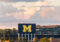 Big fluffy clouds hover over the Michigan Stadium Scoreboard.
