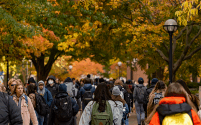 Michigan students walking through the Diag among fall colors