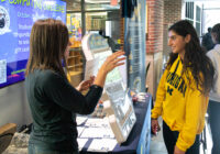 Safe Computing student table with a staff member talking to a student about online safety