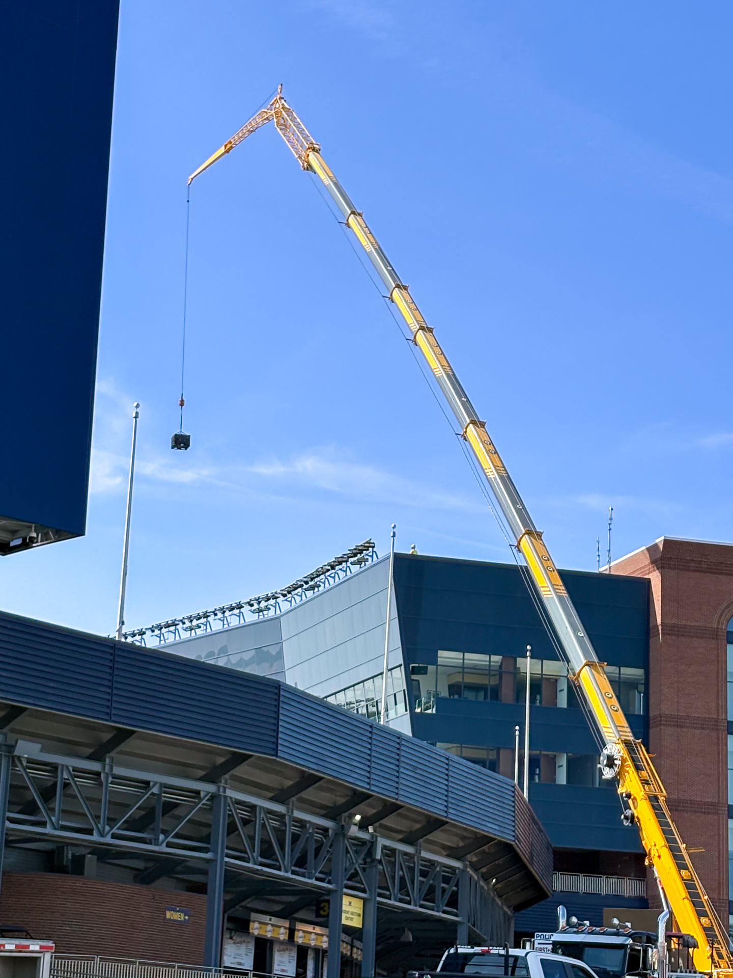Crane installing updated cellular in Michigan Stadium