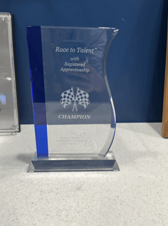Race to Talent Champion award sitting on a desk.