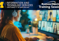 A person sits at a computer attending a virtual training session, with the University of Michigan’s Information and Technology Services and Business Objects Training Session logos visible at the top.