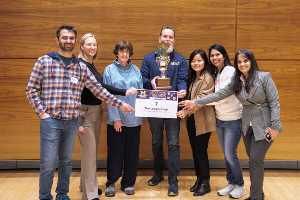 The Pitch 7 team, The Legacy Loop: AI Powered Knowledge Transfer System, with their first place trophy.