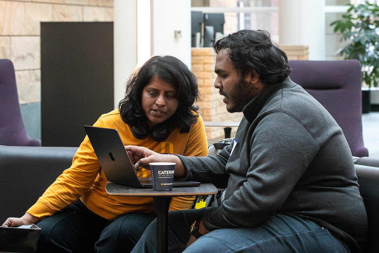 Two members of pitch 10 working on their hack