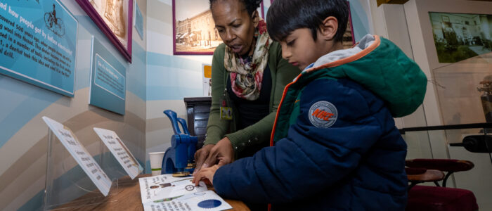 The Sindecuse Museum of Dentistry, housed within the School of Dentistry, is one of a handful of museums throughout the world devoted to preserving and exhibiting the history of dentistry on November 19, 2025. A child and an adult looking through a book.