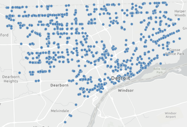 Grey scale map of Detroit with lots of blue dots representing various data points