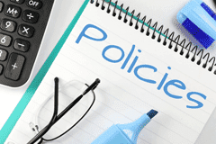 Image of a notepad with the word policy written on it.