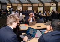 The 2026 ITS Interns sit around a table collaborating on their first day.