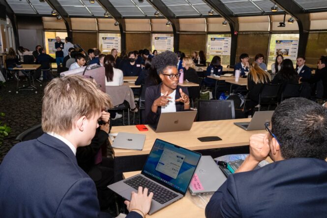 The 2026 ITS Interns sit around a table collaborating on their first day.