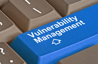 A blue keyboard button with the words vulnerability management.