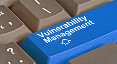 A blue keyboard button with the words vulnerability management.