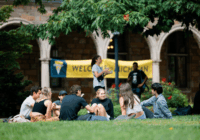 Students in front of a welcome sign on the Diag