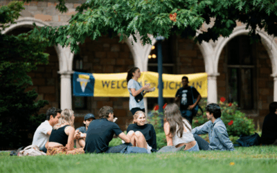 Students in front of a welcome sign on the Diag