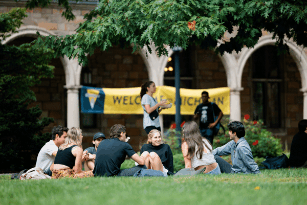 Students in front of a welcome sign on the Diag